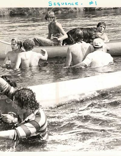 Teenage boys in water with swamped canoe Hanmer Race